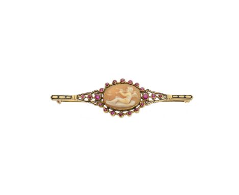 A late 19th century shell cameo, enamel and ruby memorial brooch, the oval shell cameo depicting an angel playing two trumpet