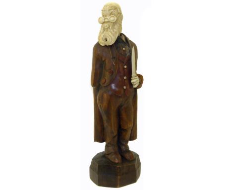 An early 20th Century German carved wood and ivory automaton, modelled as a whistling gentleman with carved ivory head and sw