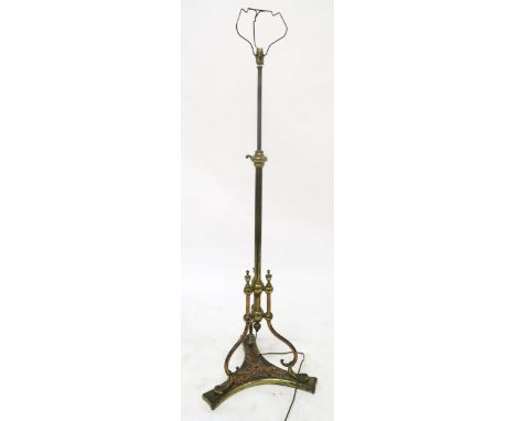 A brass adjustable standard lamp on scrolled tripod base Condition Report:Available upon request
