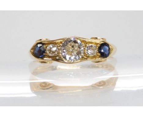 An 18ct diamond and sapphire five stone ring, the central diamond approx .40cts, size L 1/2, weighs 2.8gms Condition Report:A