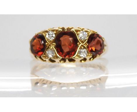 A Liberty and Co 18ct gold garnet and diamond ring, size Q 1/2, weight 3.9gms Condition Report:Available upon request