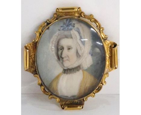 CONTINENTAL SCHOOL PORTRAIT MINIATURE&nbsp; Lady wearing a ribbon tied lace cap, monogrammed, in gilt metal scroll mount, 5 x