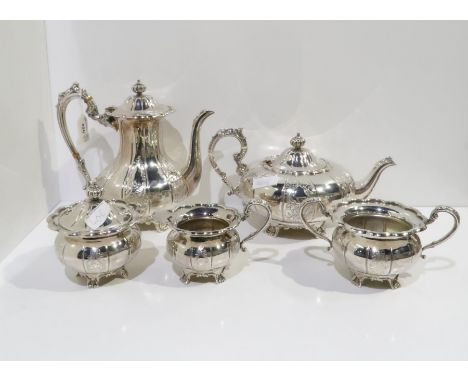 A five piece EPNS tea service, the teapot of melon form, all with chased scrolling foliate decoration, with applied scrolling