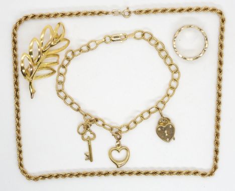 A 9ct leaf shaped brooch, a 9ct rope chain 38cm long, a 9ct bracelet hung with charms and a celtic knotwork ring, weight toge