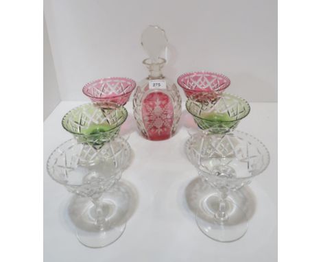 A set of six Tudor champagne cocktail glasses in cranberry, clear and green, together with a cranberry flashed and cut decant