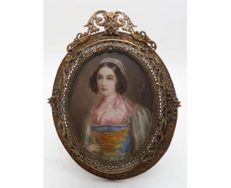 CONTINENTAL SCHOOL PORTRAIT MINIATURE Young woman wearing lace cap and bound bodice, signed, in gilt pierced easel frame, 8.5