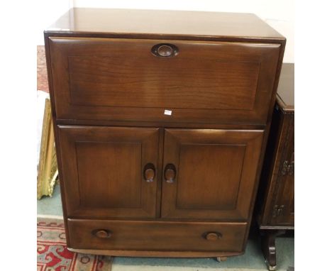 A mid 20th elm and beech Ercol serving cabinet, 109cm high x 83cm wide x 46cm deep Condition Report:Available upon request