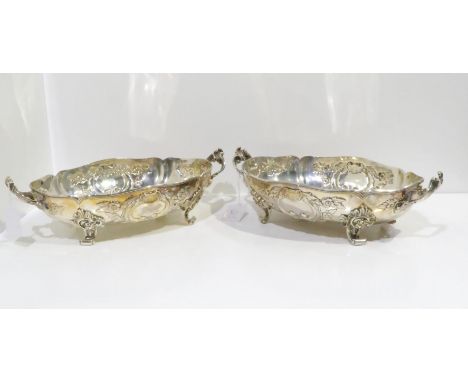 Two Danish silver twin handled fruit baskets, both of lobed form, with repousse scrolling foliate decoration surrounding init