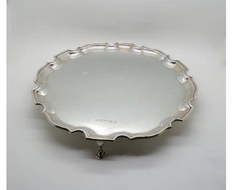 An Elizabeth II silver salver, with chippendale piecrust rim, on three hoof feet, by Francis Howard Ltd, Sheffield 1977, with
