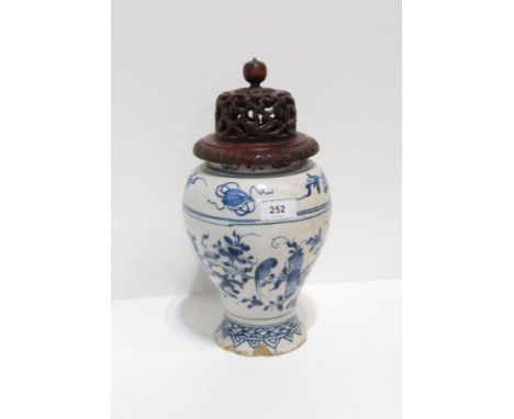 A Delftware vase / jar with floral decoration, 23cm high, with a wooden lid Condition Report:Available upon request