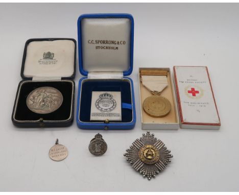 A silver Regular Army Reserves of Officers badge together with a Scots Guards badge, A WW1 British Red Cross for war services