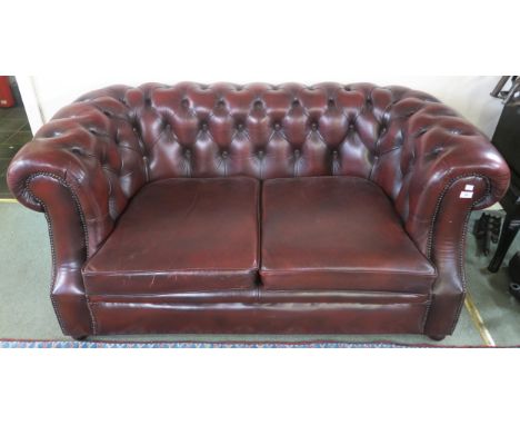 A 20th century oxblood leather upholstered Chesterfield style two seater club sofa, 73cm high x 160cm wide x 94cm deep Condit