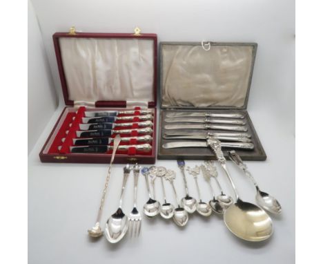 A collection of silver including silver and enamel city souvenir spoons, some stamped sterling, a cased set of silver handled