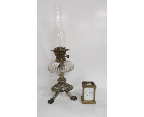 A brass cased carriage clock and an oil lamp with Trademark in Lux Way to buttons Condition Report:Available upon request