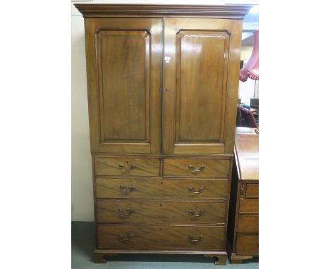 A Victorian mahogany linen press with moulded cornice above two panel doors concealing linen drawers above two short and thre