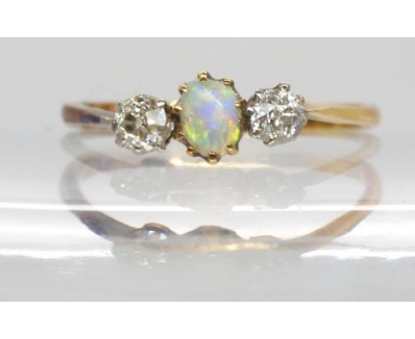 An 18ct and platinum diamond and opal three stone ring, approx .20 cts of diamonds Condition Report:Available upon request