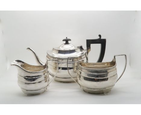 A matched three piece silver tea service, the bodies with banding and reeded rims, by S.Blanckensee &amp; Sons, Chester 1929,