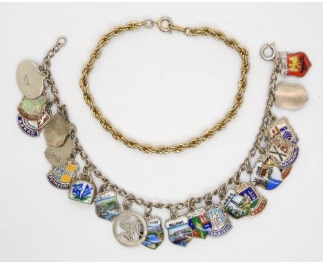 A silver charm bracelet with silver and enamel place name charms, together with a gold plated bracelet Condition Report:Not a