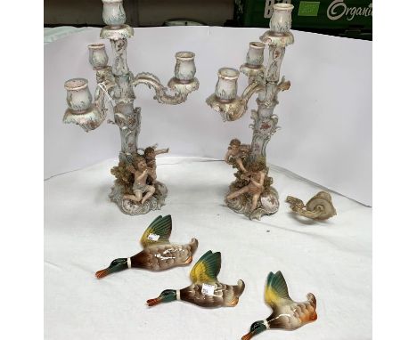 A pair of 19th century Dresden 3 branch candelabra heavily encrusted with foliage, cherubs etc ht 40cm (both have branches br