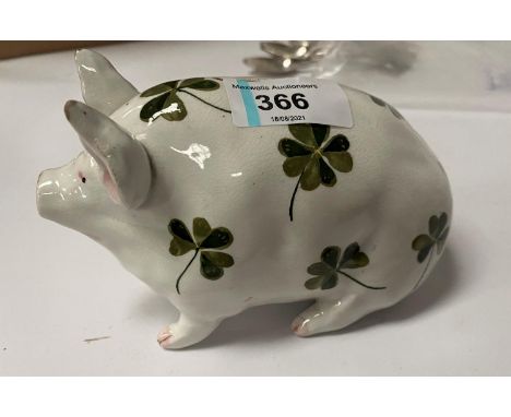 A Wemyss piggy bank, decorated in the clover pattern, marked 'WEMYSS' to base, 9.5cm high, 16cm long 