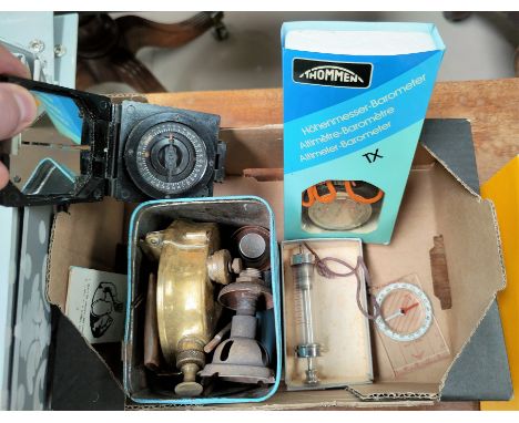 A selection of collectables: a primus stove; a prismatic compass; a Silva compass; an altimeter/barometer
