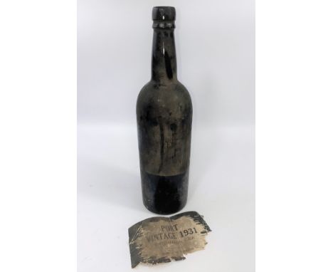 A bottle of port labelled "1931 Vintage".&nbsp; The bottle is such a dark green that it is difficult to tell the colour of th