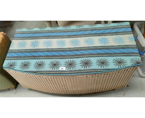 A Lloyd Loom ottoman; a 19th century tin trunk 