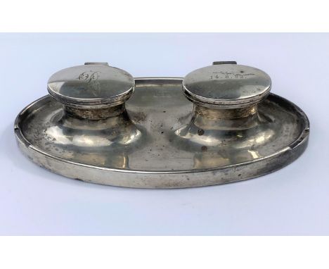 A hallmarked silver double inkwell on oval weighted base, inscribed, Birmingham 1946 