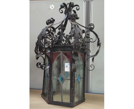 A cast metal hall light in the Gothic manner with 6 various leaded glass panels 