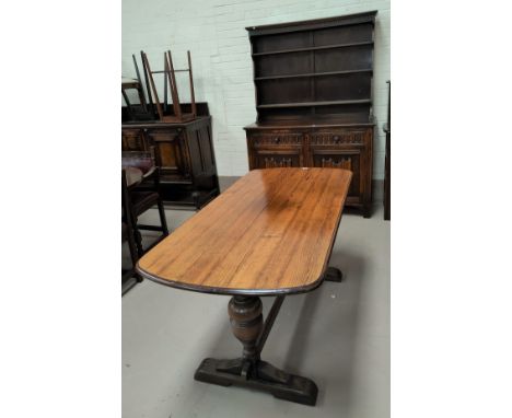 A near matching reproduction oak dining suite with carved and linen fold decoration comprising rounded rectangular table, 6 l