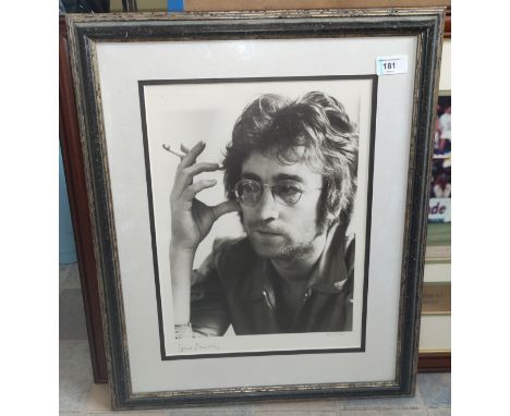 A limited edition photo print of John Lennon smoking, signed Spud Murphy in pencil 497/750 