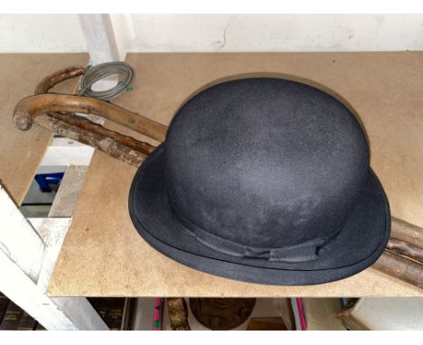 A 1930's aneroid barometer, 2 walking sticks and a bowler hat 