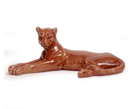 A 20TH CENTURY MINTON CERAMIC RECUMBENT LIONESS in red glaze with impress mark to base 21cm approximately overall