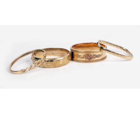 A COLLECTION OF BANGLES comprising two hinged oval bangles, each with foliate scroll decoration, a 9ct gold hinged bangle and