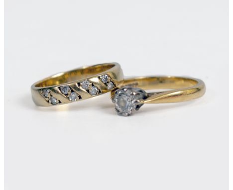 TWO DIAMOND SET RINGS comprising a single stone ring, the round brilliant-cut diamond in claw setting, 18ct gold mounted, and