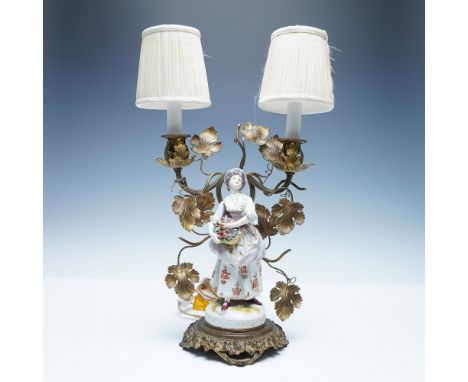 An exquisite antique figural table lamp featuring a finely detailed porcelain lady dressed in traditional 18th-century attire