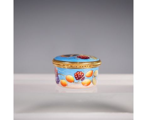 A Moorcroft small oval enamel pot featuring a charming hand-painted design of ripe berries and fruit set against a soft blue 