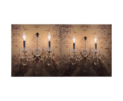 Elegant Chambord crystal wall sconces featuring a two-light design with cut crystal bobeches, cascading crystal drops, and an