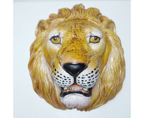 A striking Italian Majolica ceramic lion head wall plaque, intricately hand-painted and glazed. This sculptural piece capture
