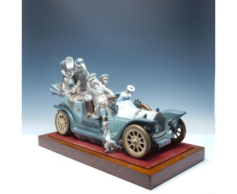 A whimsical Lladro porcelain sculpture titled Antique Car, capturing the charm of a vintage automobile ride with a family enj