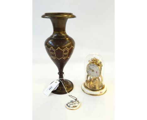 Benares brass vase, Schatz eight-day clock with floral decoration and a porcelain whiskey decanter label (3) 