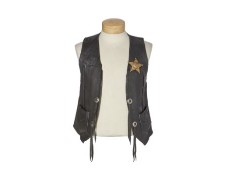 A Stage-worn George Harrison Vest1974black leather vest with star-shaped silver metal 'Apollo / Police' badge to left breast,