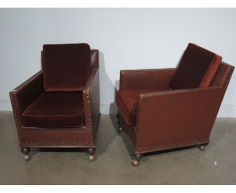 A pair of Art Deco leatherette club chairs on later castors
