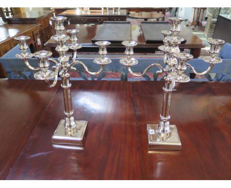 A pair of plated five light candelabra on square bases - Height 55cm x Width 38cm