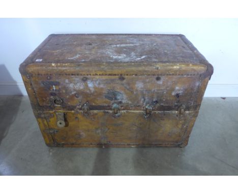 An early 20th century leather and metal bound travelling wardrobe trunk with interior drawers - Height 74cm x Width 102cm x D