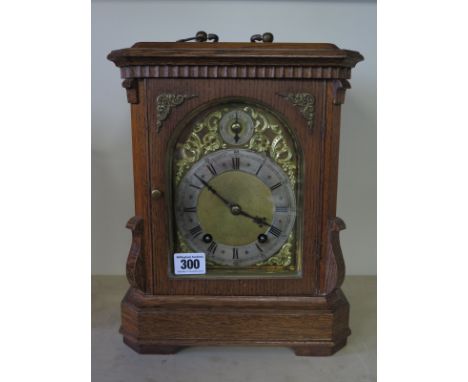 A good oak bracket clock with a silvered chapter ring and ting tang striking on two gongs - Height 33cm x Width 24cm - Moveme