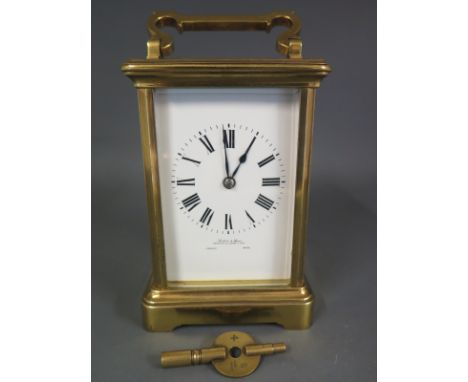 A brass cased Carriage clock with French movement and enamelled dial, Roman numerals to dial with five rectangular bevelled g