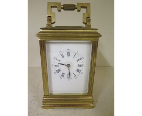 A brass carriage clock with an 8 day movement - Height 17cm - working