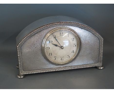 An Edwardian plated dome top mantel clock with a French movement having metallic dial with separate chapter ring, Arabic nume