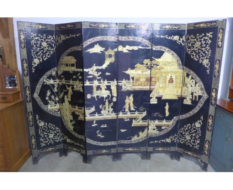 An early 20th century six panel chinoiserie folding screen with gilt decoration on a black background - Height 184cm x Width 